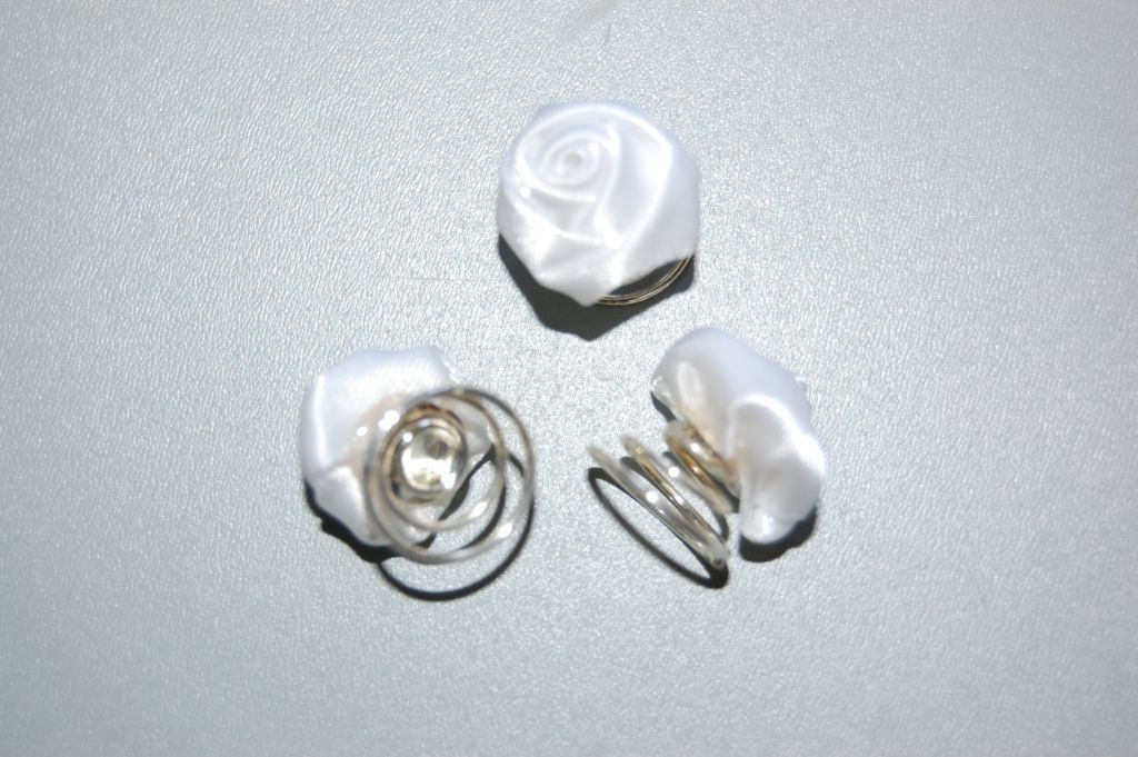 Three white fabric roses